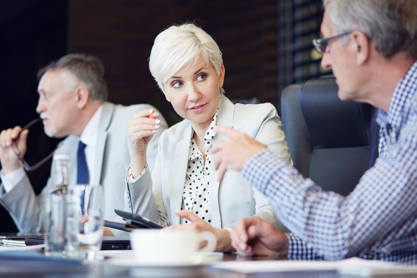 Senior leadership team in discussion around a boardroom table
