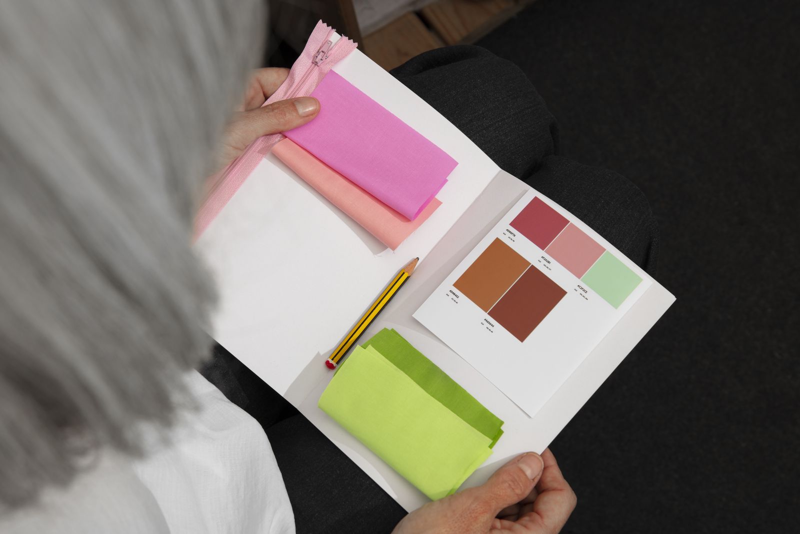 Hands holding open a brand swatch book
