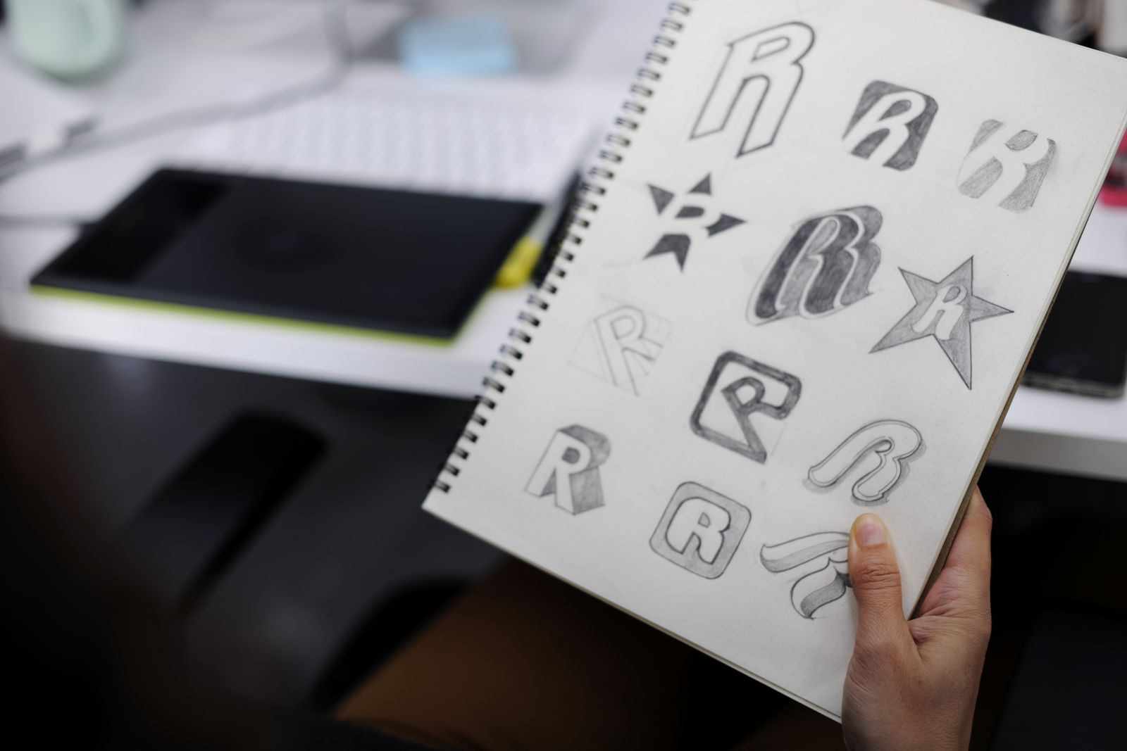 Notebook page of logo design sketches