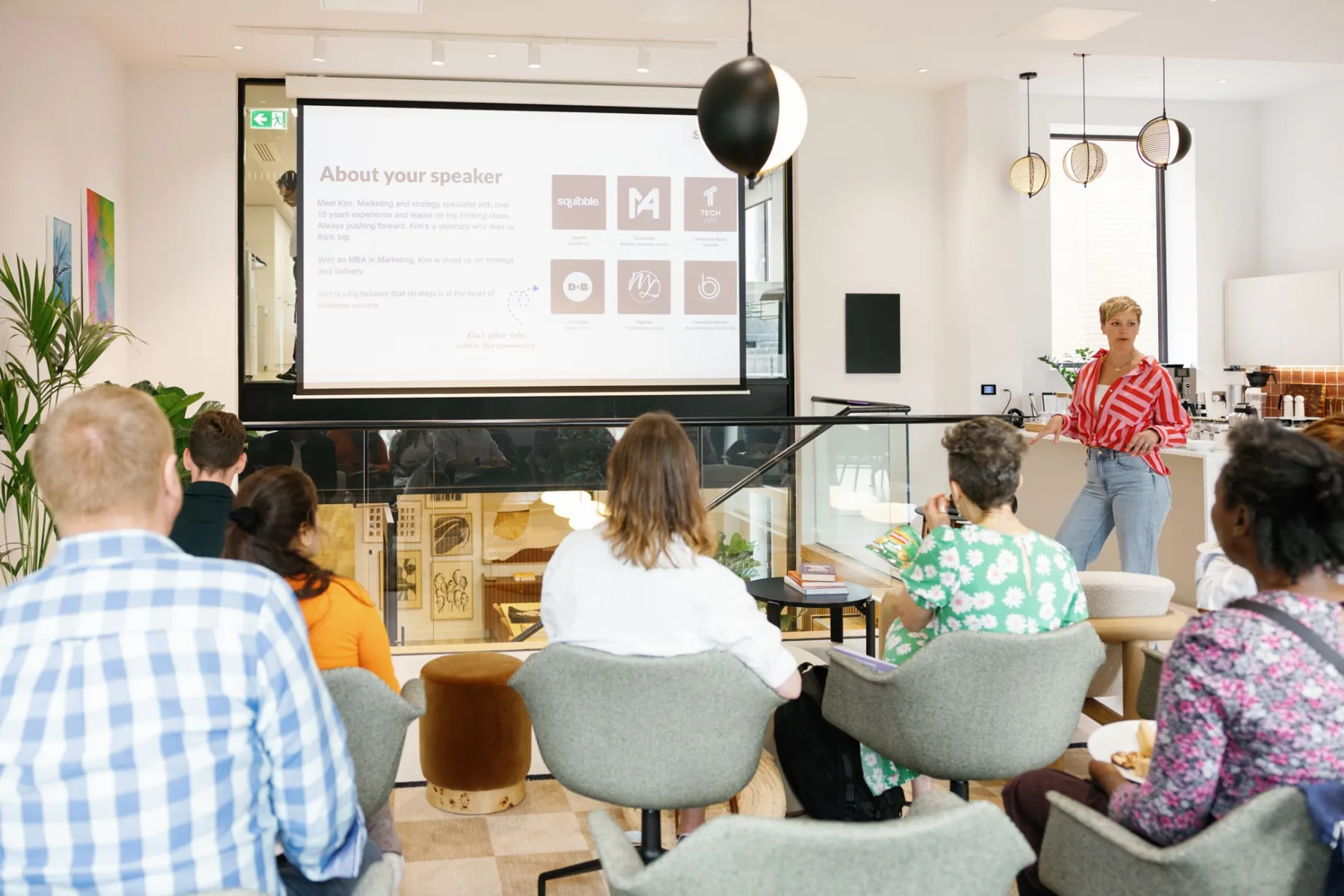 Kim speaking to a room of marketers