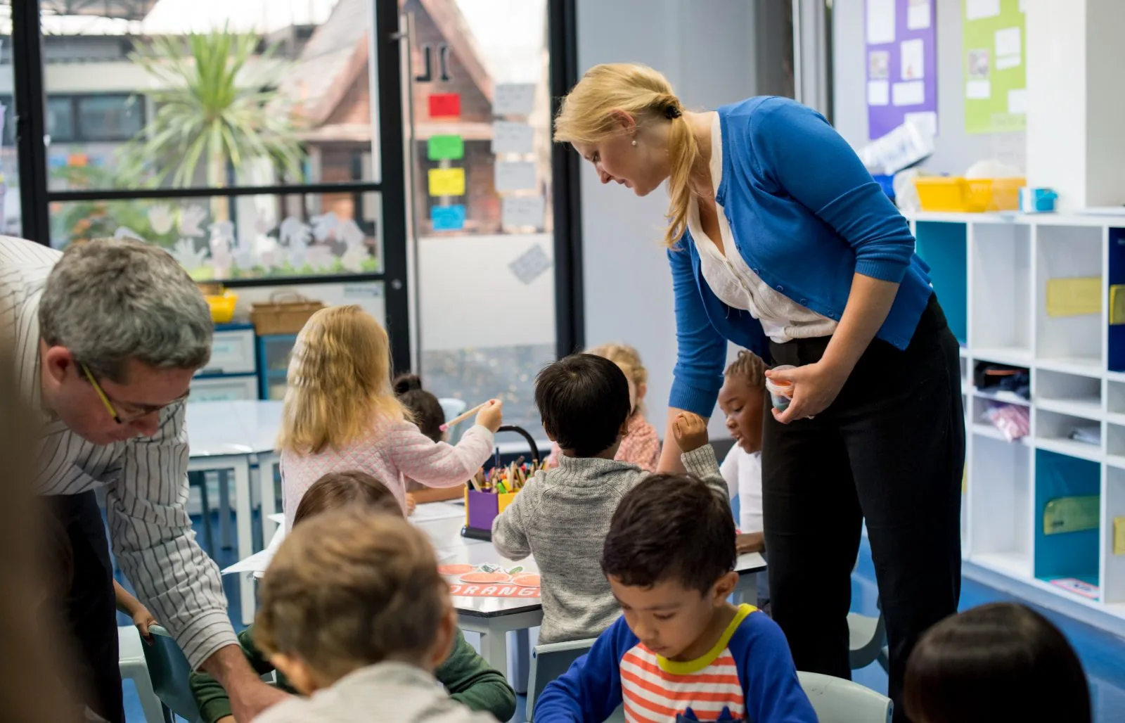 Teachers working with children in a primary classroom