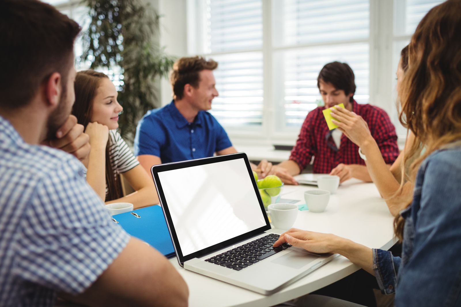 Team reviewing a website on a laptop in a meeting